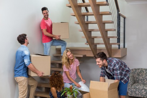 Furniture collection team handling bulky items in a West Kensington street