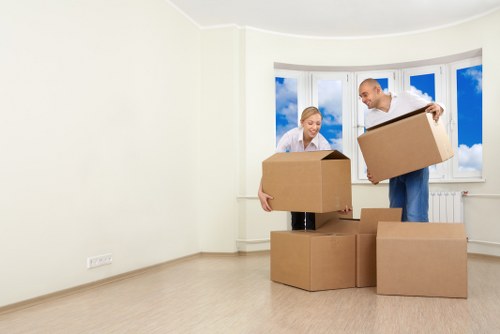 Residential flat move with furniture being carried down stairs in West Kensington