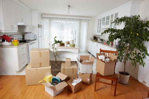 Moving van and helper loading household items for a man and van service