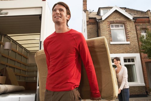 Careful packing of fragile household items during a local West Kensington move